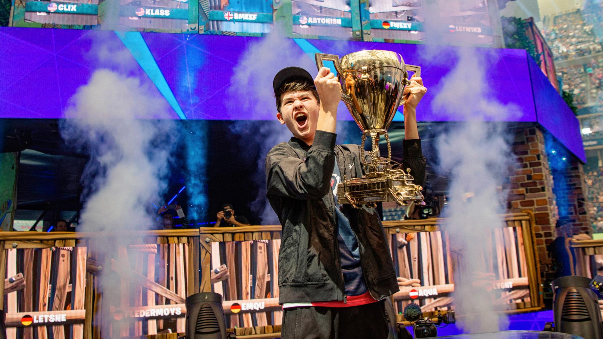 Bugha lifting Fortnite World Cup trophy 2019