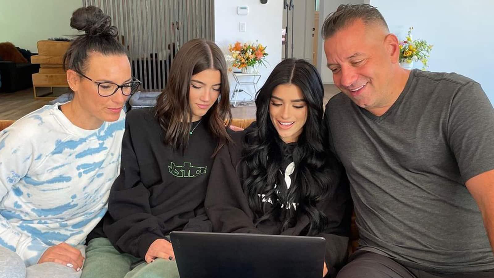 The D'Amelio family gathered round a computer screen