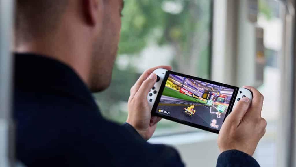 Image of someone holding a Nintendo Switch.