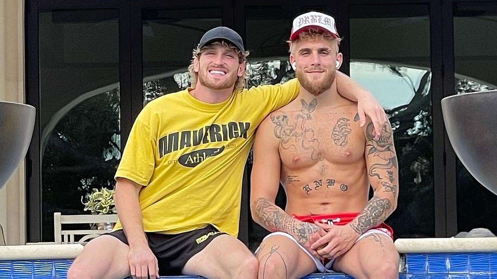 Logan Paul and Jake Paul sitting by pool