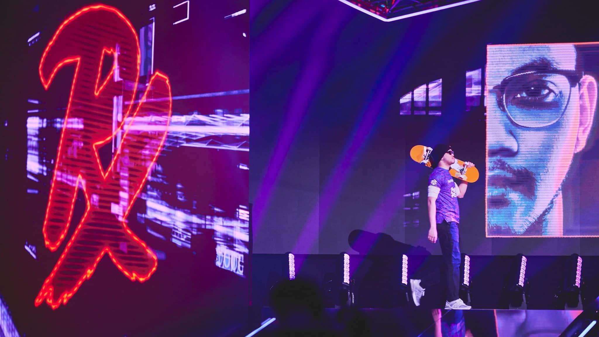 Benkai on stage with a beanie and skateboard in hand