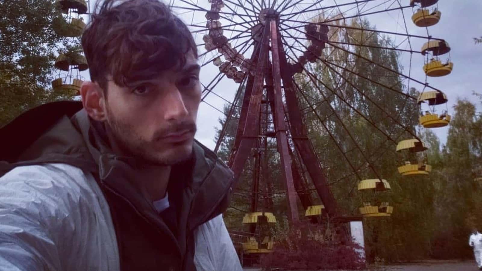 Ice Poseidon standing in front of Ferris wheel