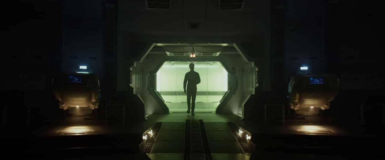 a dark space station with a silhouette of a man in the centre from Prometheus 