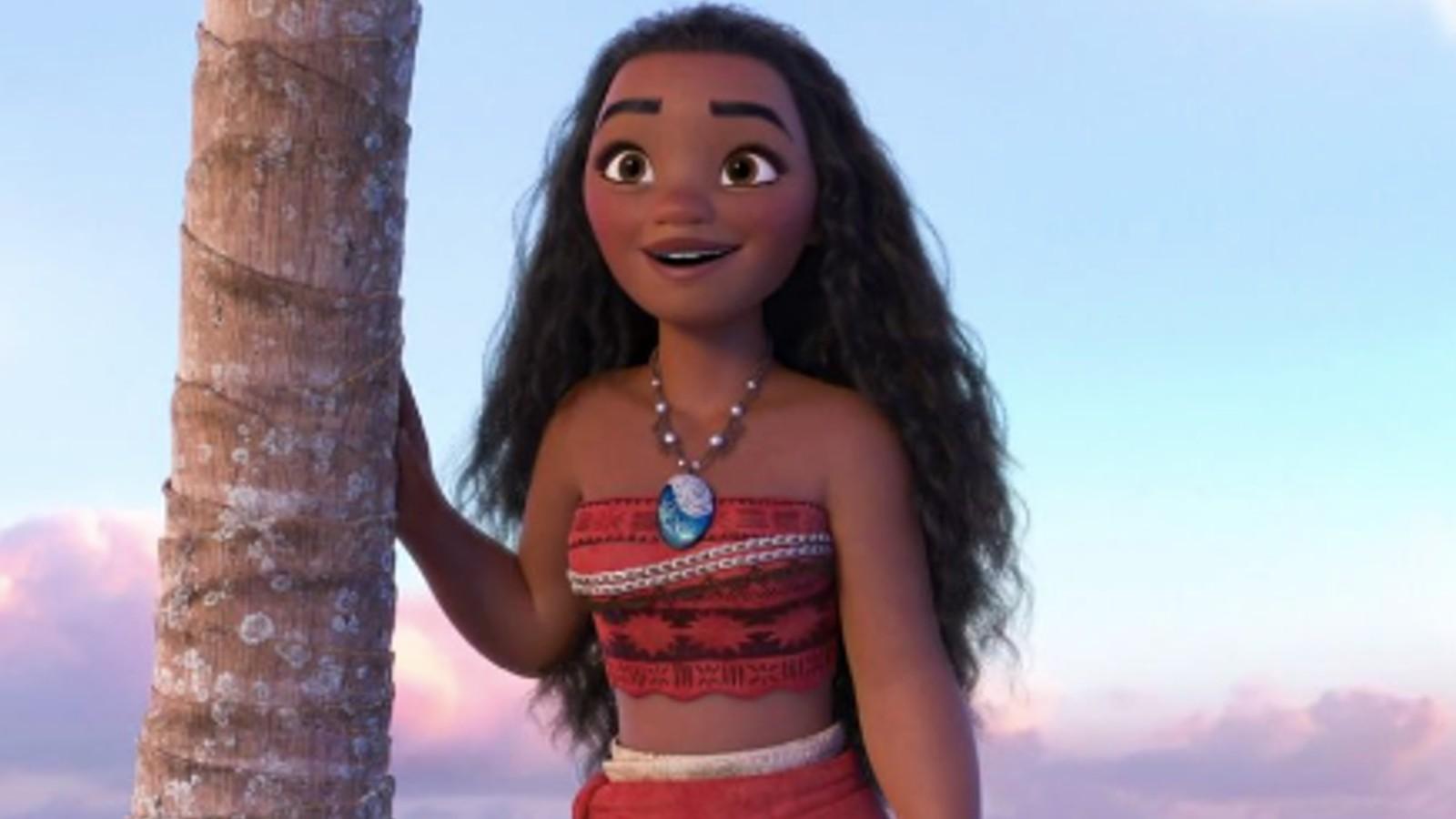 Moana stands by a palm tree in Moana