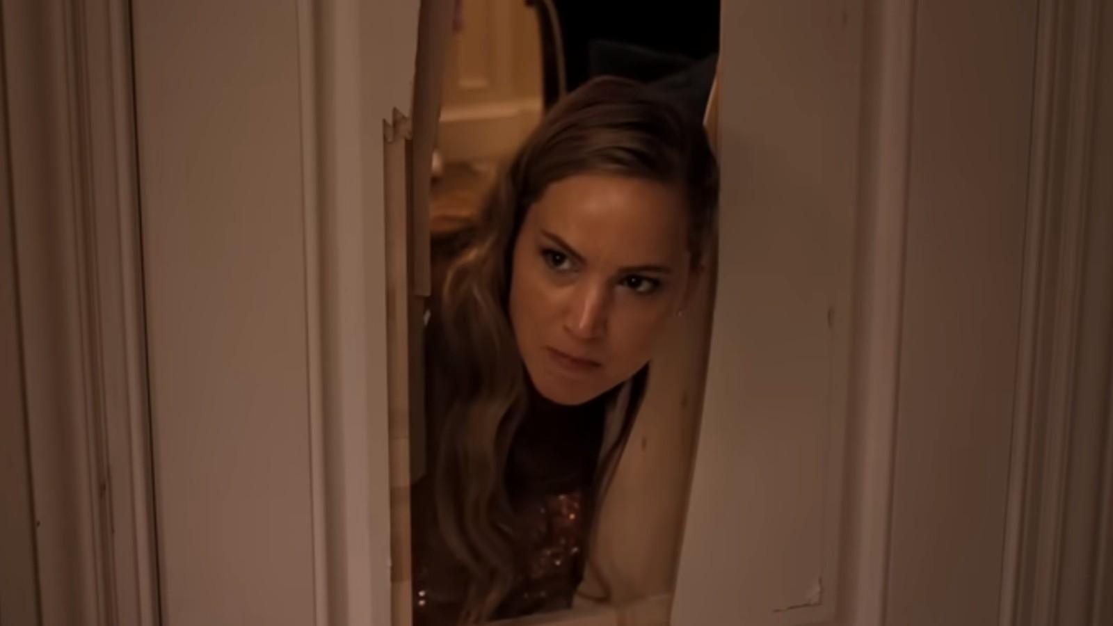 Jennifer Lawerence sticks her head through a broken door in No Hard Feelings