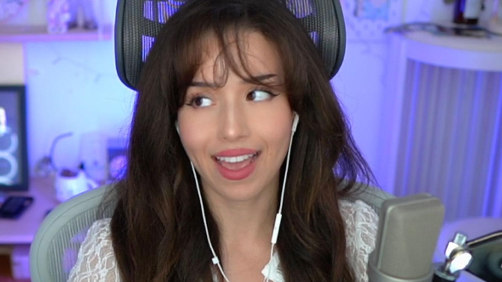 Pokimane rolling her eyes while sat at gaming setup