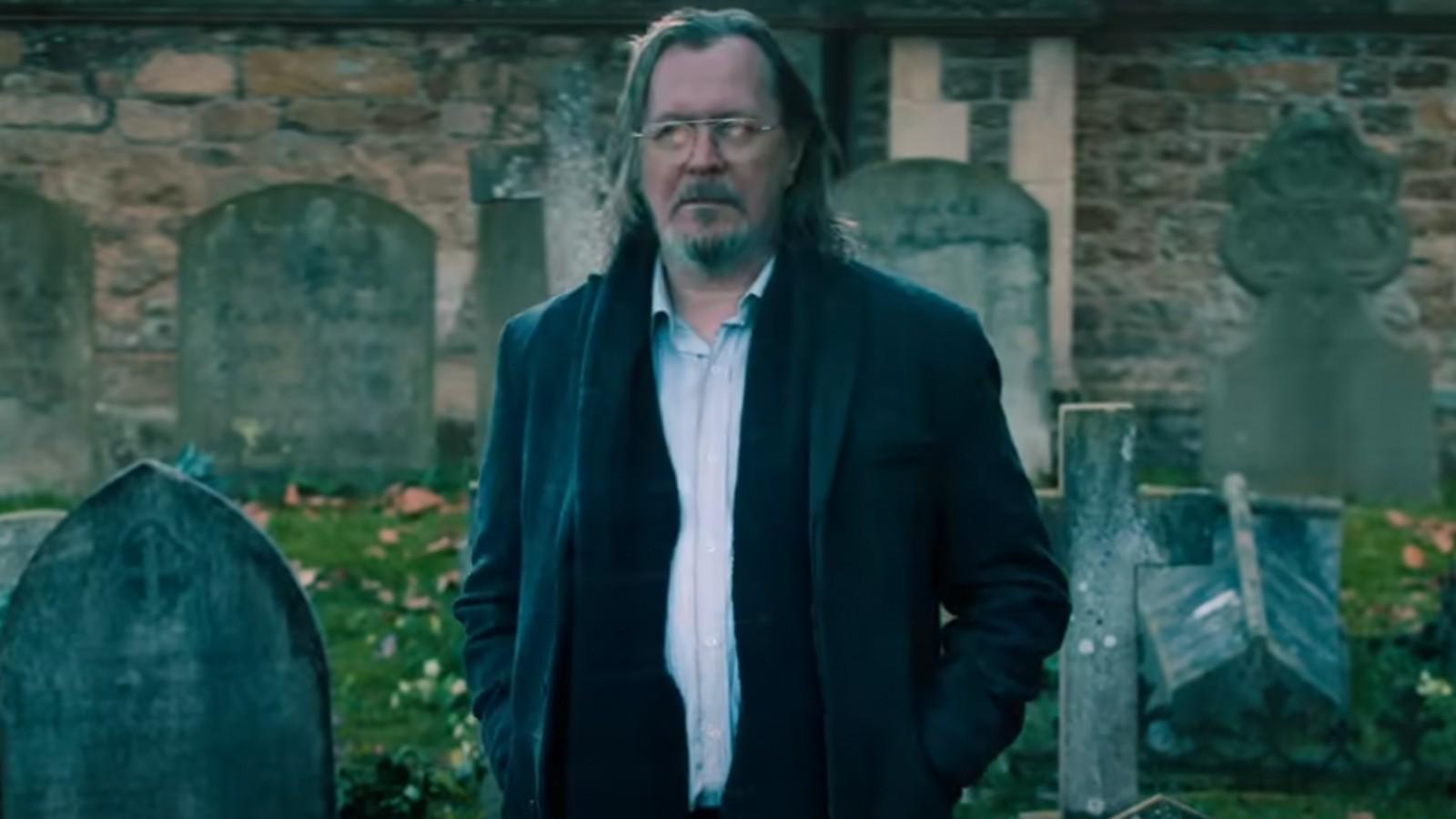 Gary Oldman as Jackson Lamb, standing in a graveyard in Season 4 of Slow Horses.