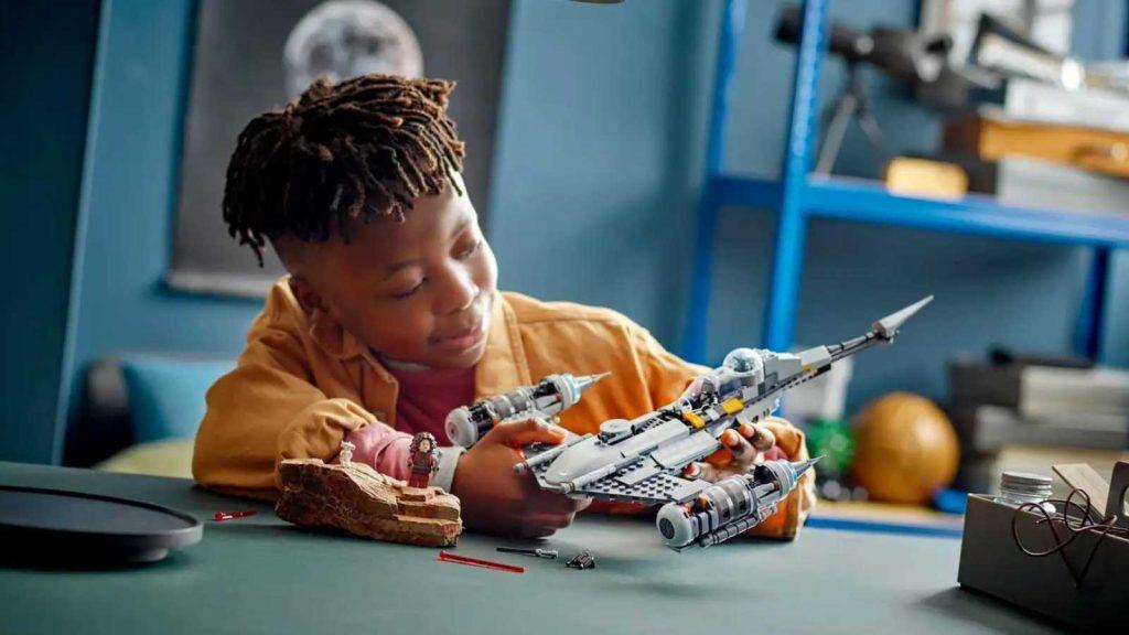 Child playing with their LEGO Star Wars The Mandalorian's N-1 Starfighter set