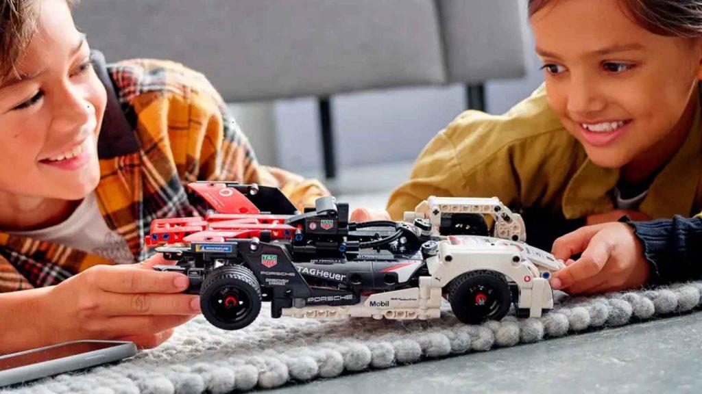 Two children with the LEGO Technic Formula E Porsche 99X Electric