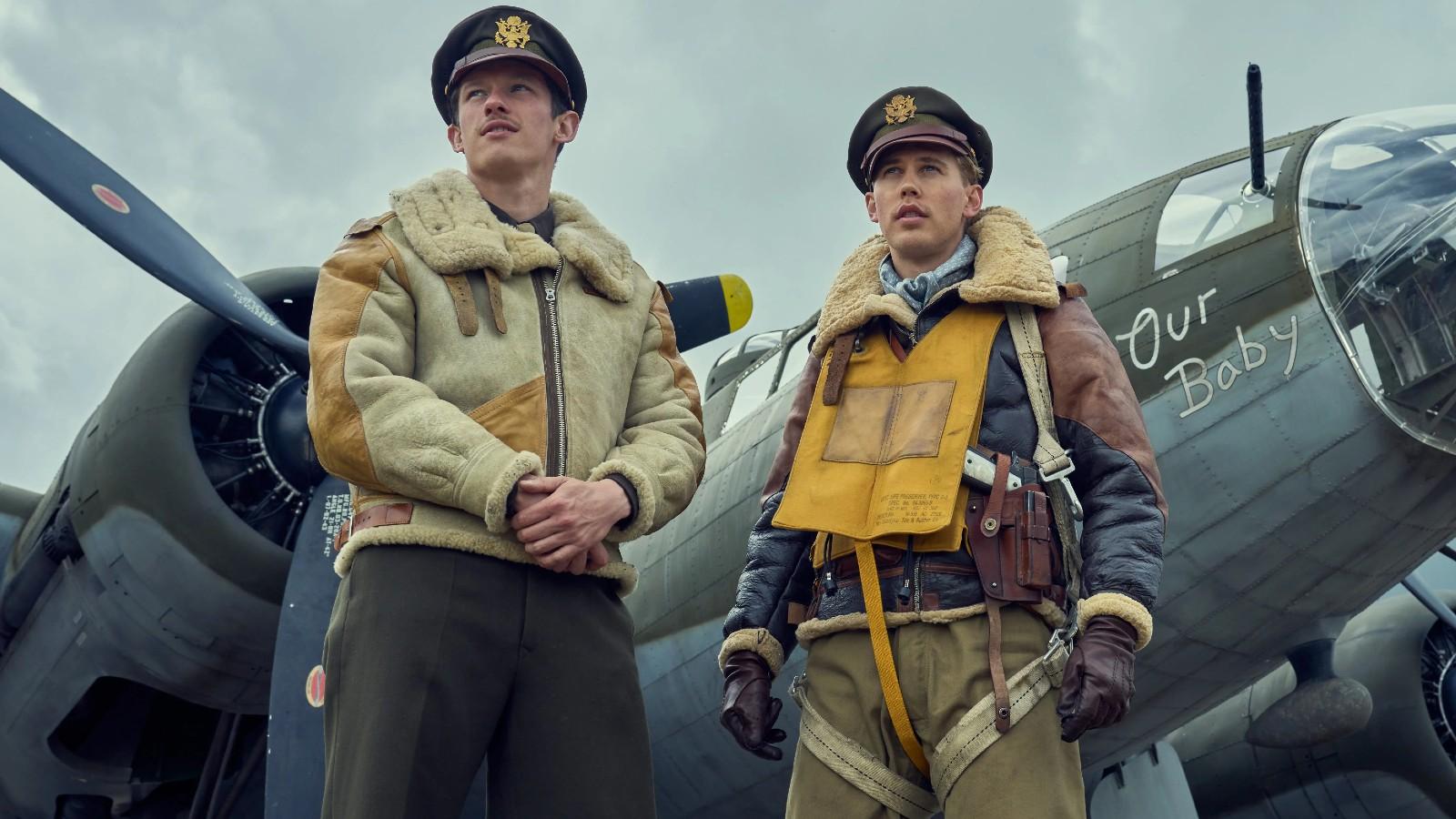 Bucky and Buck standing in front of their plane in Masters of the Air.