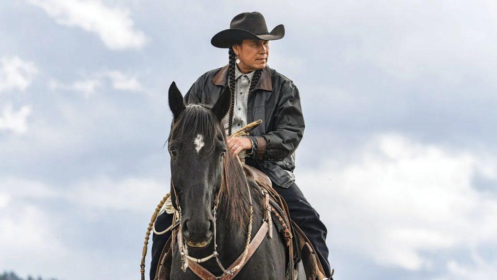 Mo Brings Plenty in Yellowstone, sitting on top of a horse