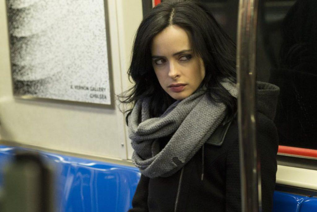 Krysten Ritter as Jessica Jones, sitting in a subway car