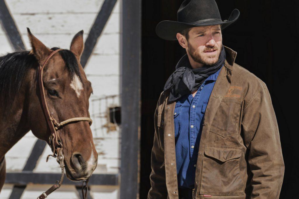 Ian Bohen as Ryan on Yellowstone, standing next to a horse