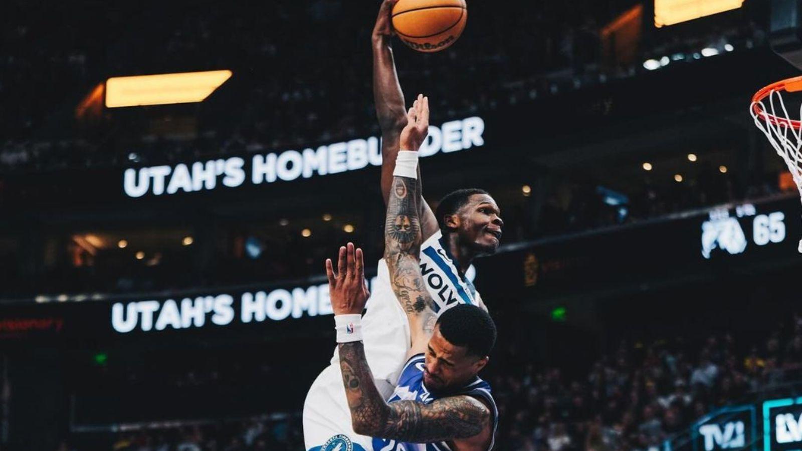 Anthony Edwards dunks over John Collins in the 2023-24 NBA season.