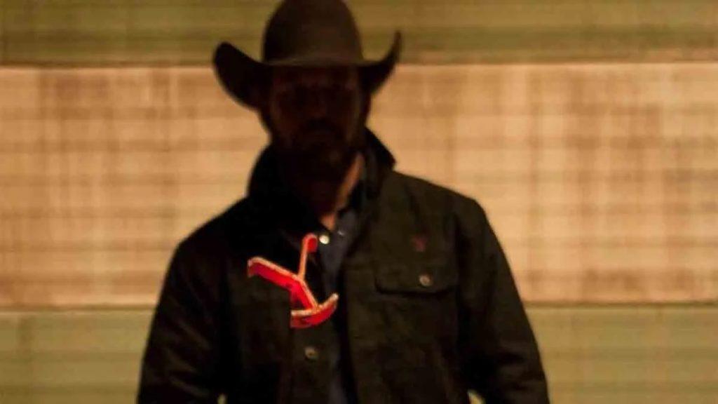 Cole Hauser as Rip Wheeler in Yellowstone, holding a branding iron