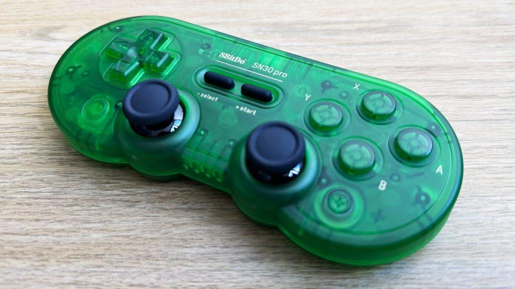 8BitDo SN30 Pro in transluscent green on a desk