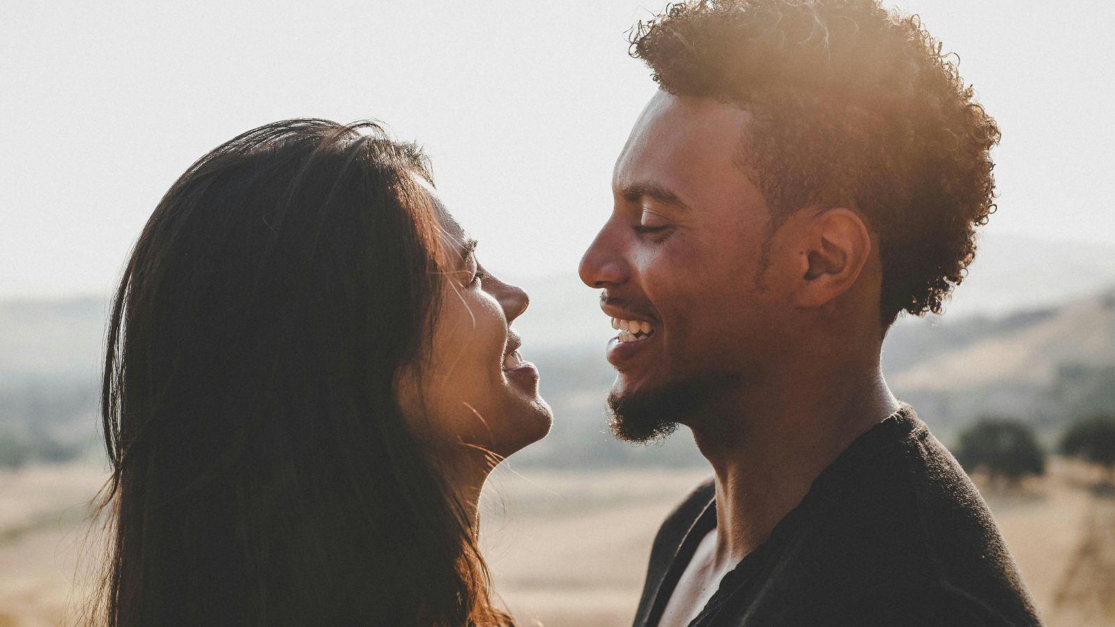 A man and woman facing each other while smiling