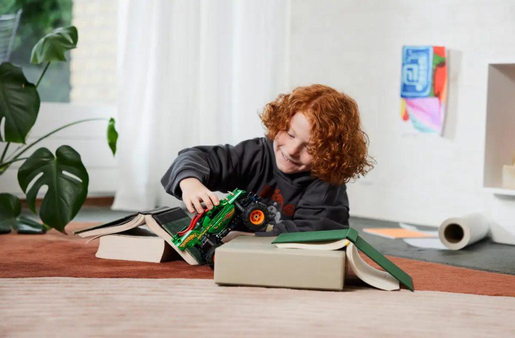 A child playing with their LEGO Technic Monster Jam Dragon 