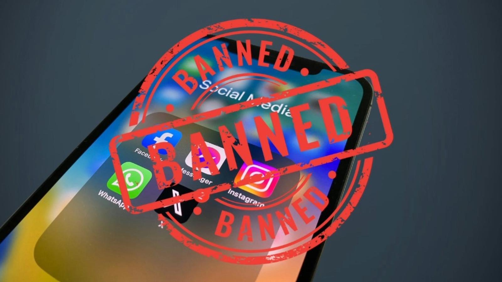 Smartphone with social media app folder having ban symbol