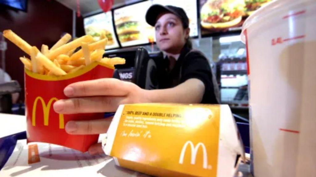 mcdonalds employee handing over fries