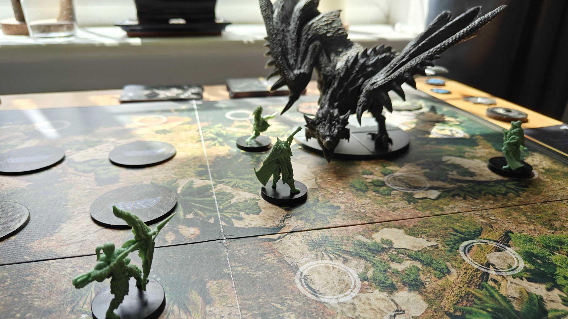 Hunters fighting a Rathalos in the Monster Hunter board game