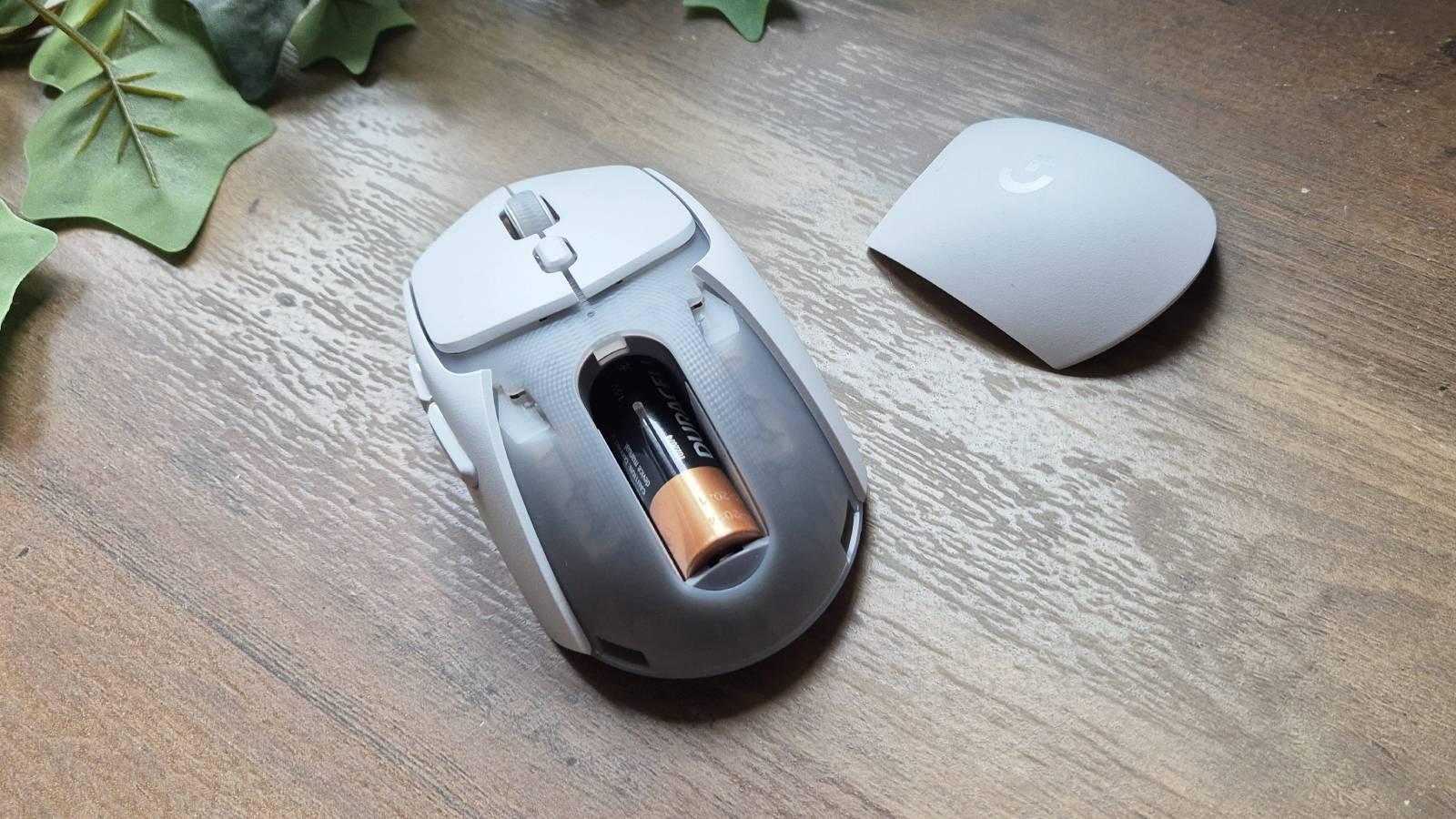 Custom photo of the Logitech G309 mouse on a wooden table.