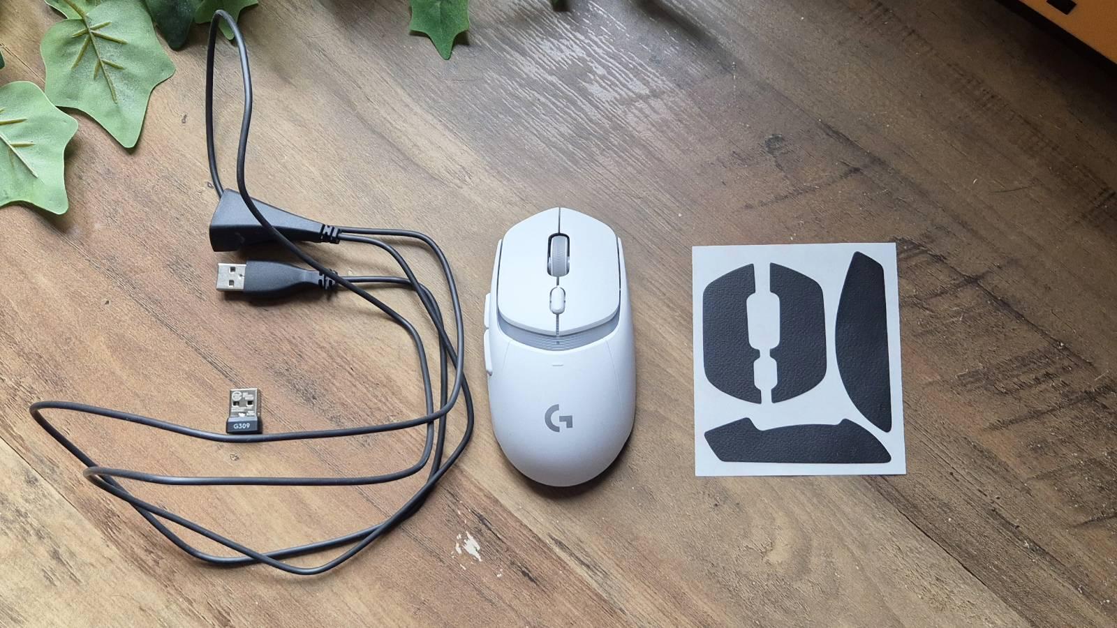 Custom photo of the Logitech G309 mouse on a wooden table.