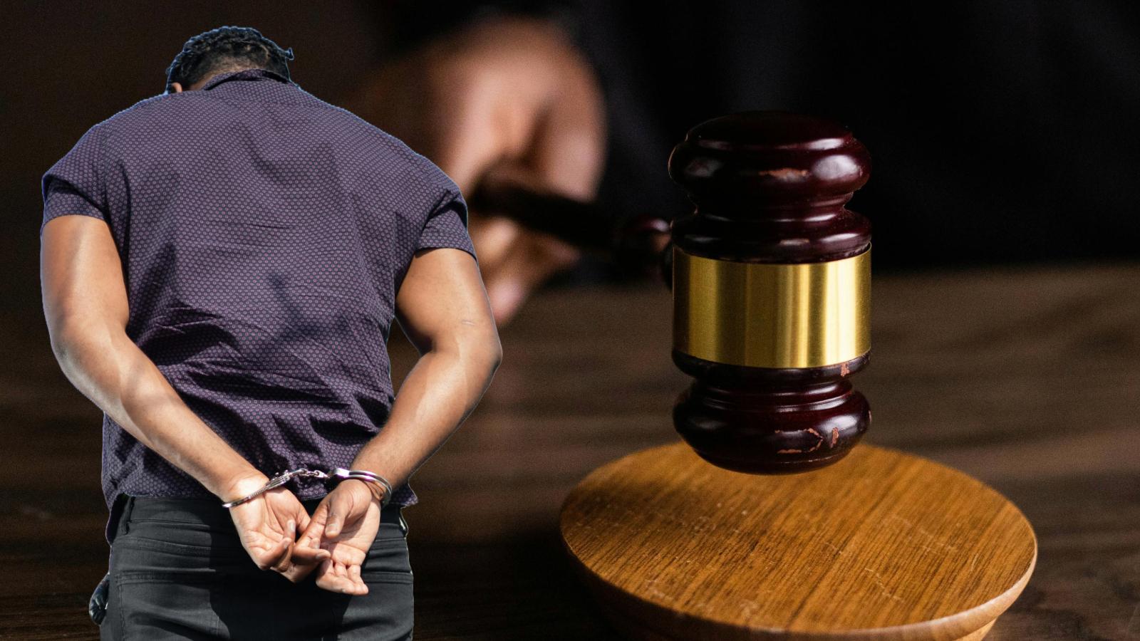 person with handcuffs next to gavel