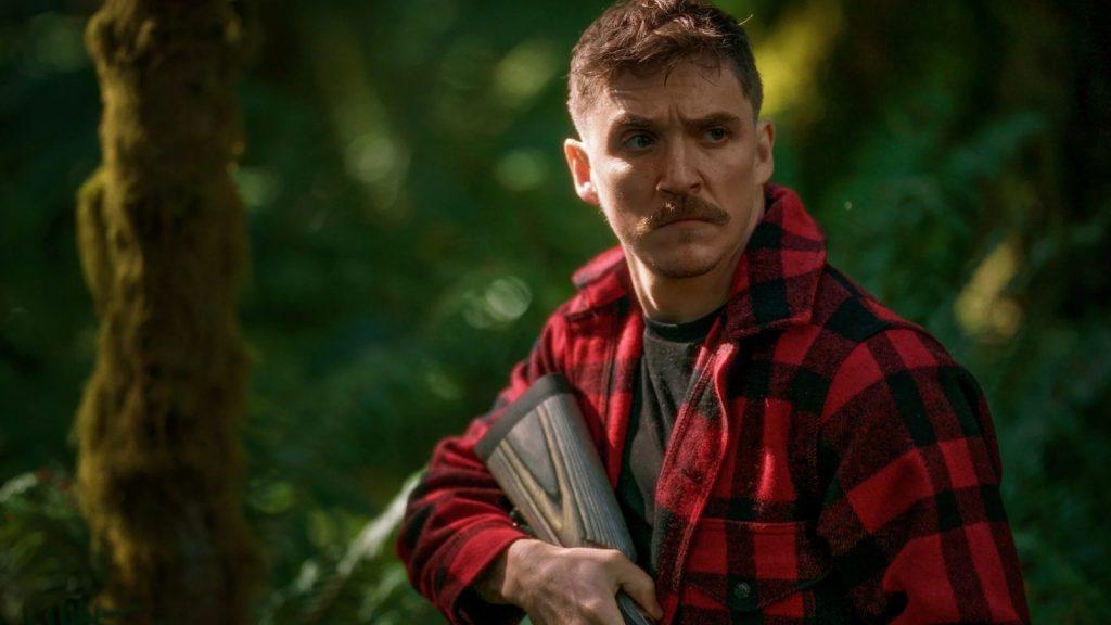 Kyle Gallner holding a rifle in Strange Darling