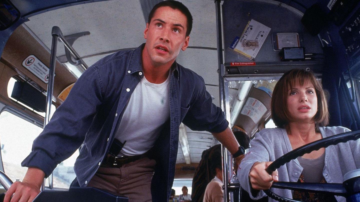 Best Keanu Reeves movies - Speed: Keanu Reeves as Jack and Sandra Bullock as Annie at the front of a bus