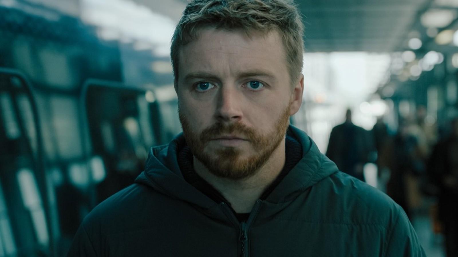 Jack Lowden at a station in Slow Horses.