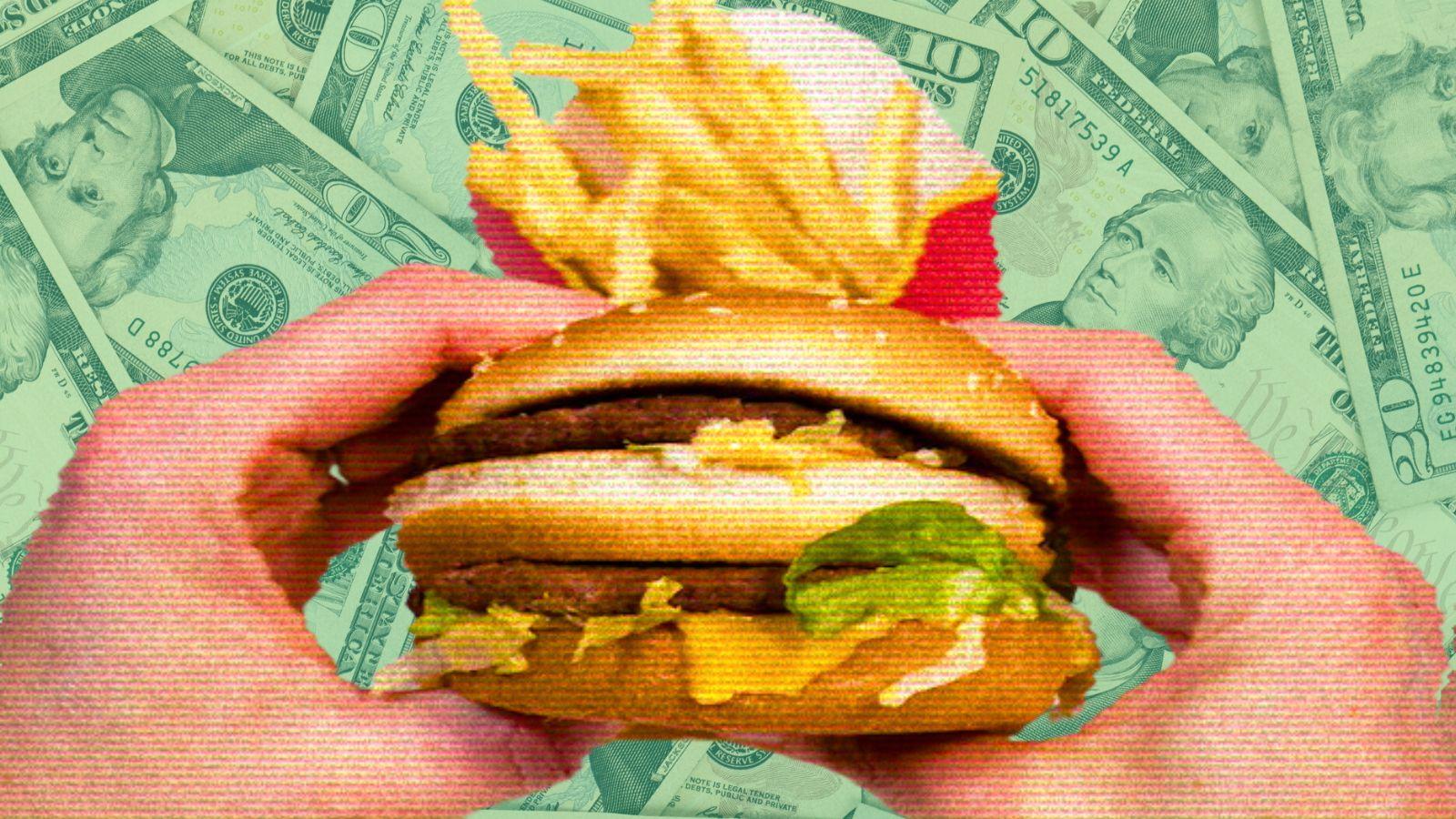 burger and fries with money in background.