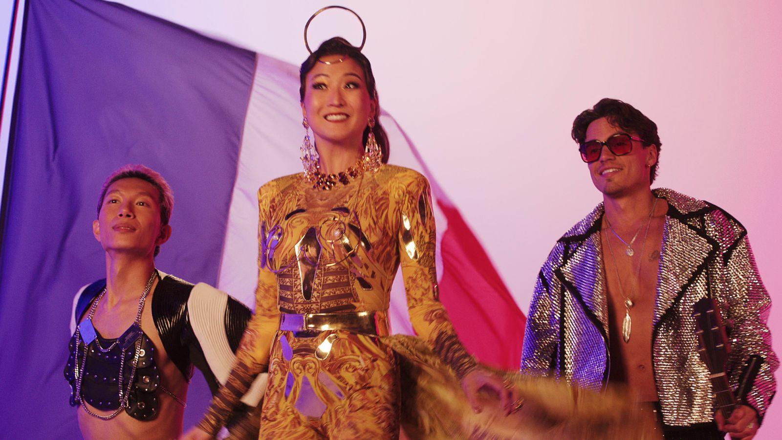 Mindy and the band at a Eurovision photoshoot in Emily in Paris