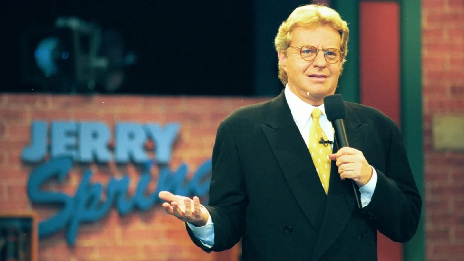 Netflix Jerry Springer documentary: Jerry Springer holding up a microphone