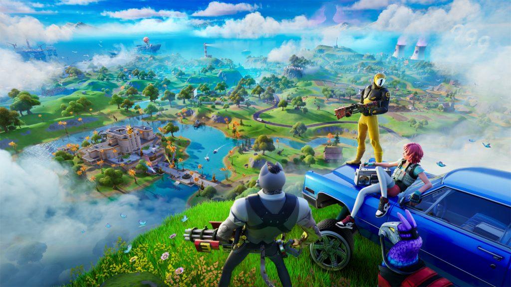 Fortnite players standing on a car on top of a hill looking down at the island