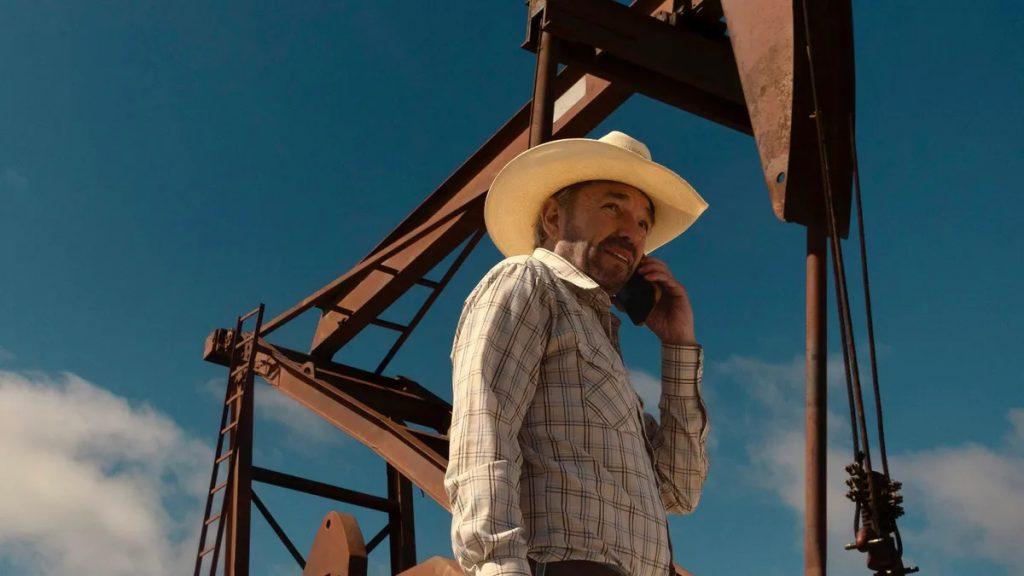 What is a Landman? Billy Bob Thornton as Tommy Norris standing by an oil rig