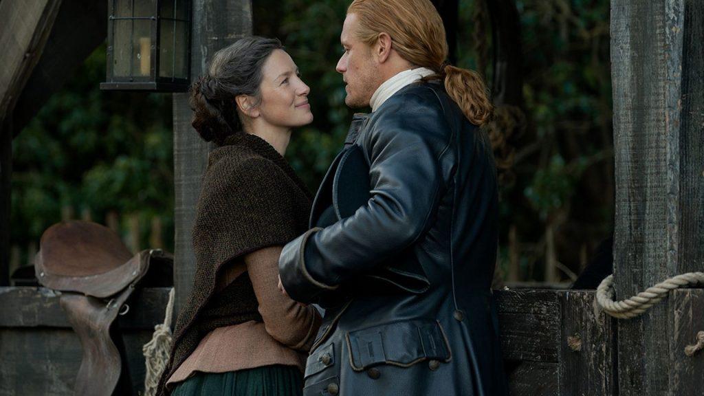 Claire smiling at Jamie in Outlander.