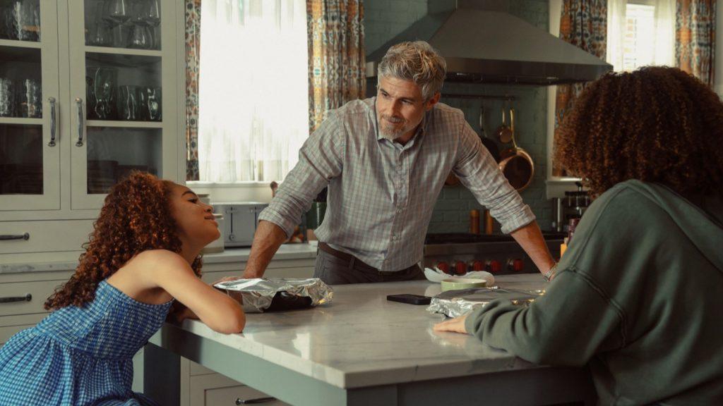 Neal and his daughters sit in the kitchen in Lioness