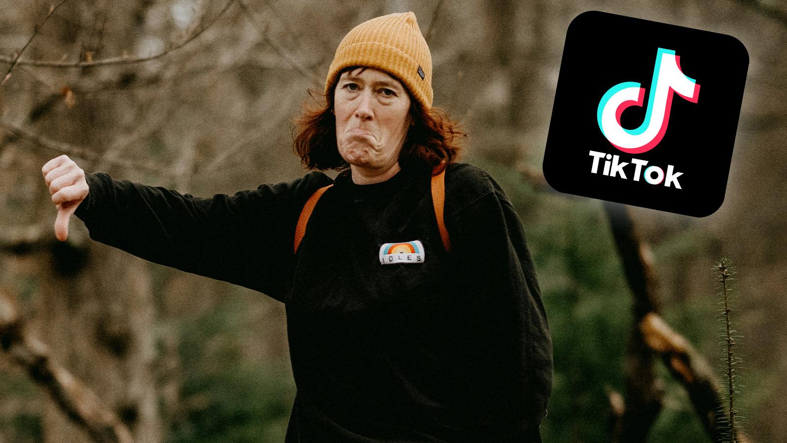 woman giving a thumbs down with a tiktok logo in the right corner